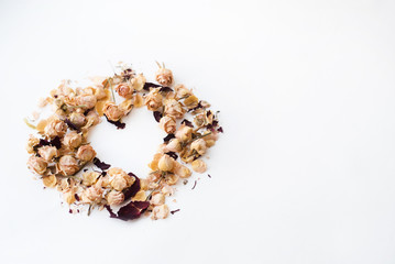 Heart symbol made of flovers and leaves on white background with place for signature