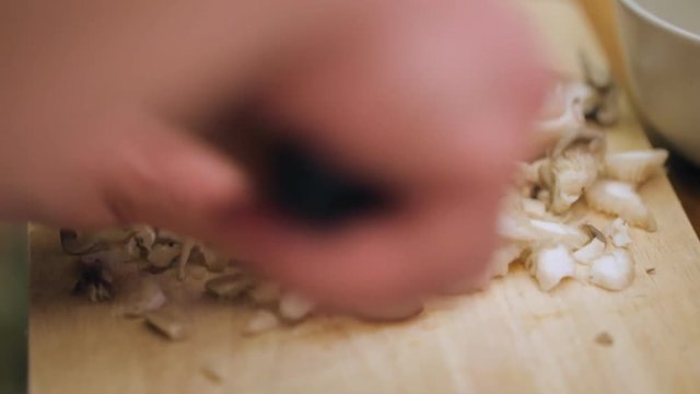 Male hands chopping mushrooms for cooking