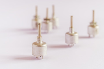 Potentiometers stand on a pink background with a fashionable zastvetkoj.