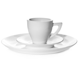two white plates and a cup on a white background