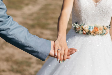 hand of bride and groom during wedding ceremony