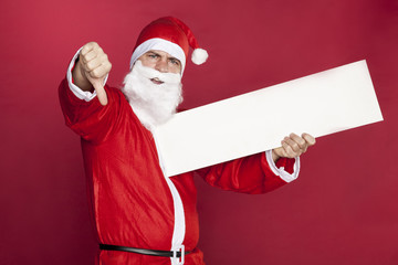 Santa Claus shows thumbs down, advertisement in hand