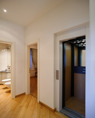 White passageway with three open doors