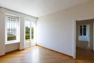 Empty white room with window