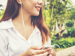 Young woman use smartphone at the park.