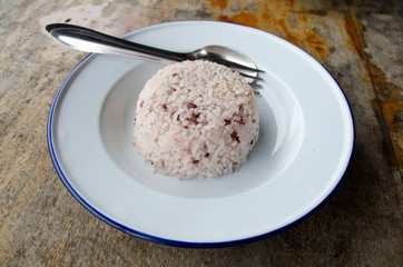 Steamed rice with chopsticks on wooden table