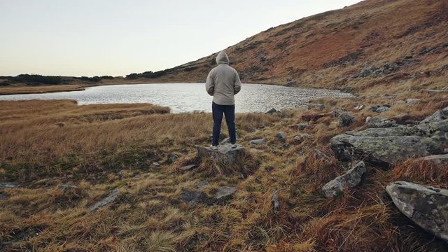 Traveler Man relaxing meditation with serene view mountains and lake landscape