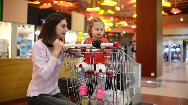 Little child girl eating an Ice Cream Gelato Sour Taste with Mom in Grocery Mall