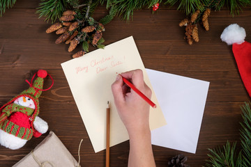 paper letter to Santa Claus on a wooden table