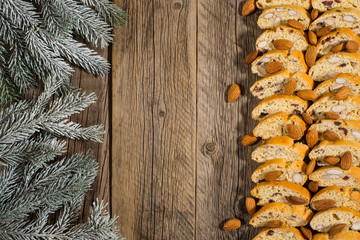 Branch spruce with biscuits and nuts on an old wooden table.