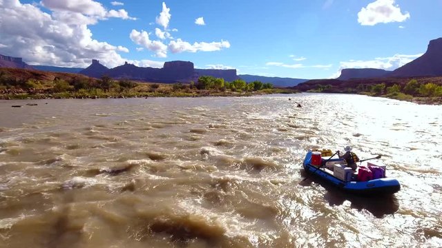 Aerial people floating down the colorado river in a dry utah desert