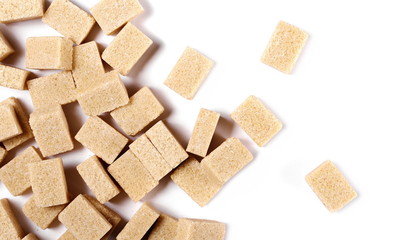 Brown cane sugar cubes isolated on white background, top view