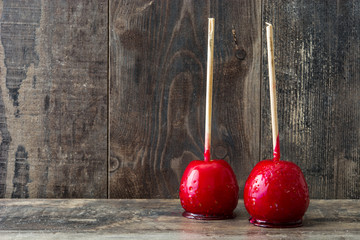 Candy Christmas apples on wooden table
