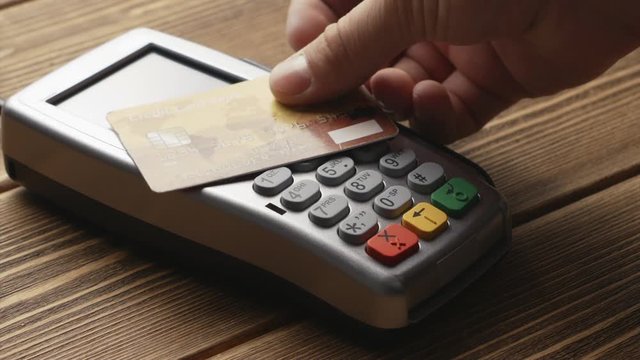 Closeup shot of person using contactless payment with credit card