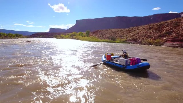 Aerial person floating down the colorado river in a dry desert