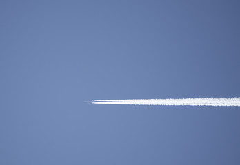 plane in flight leaving in his wake behind him