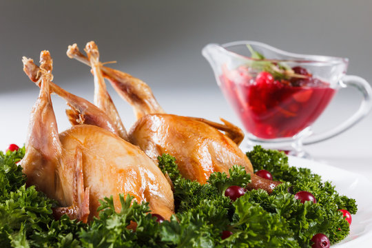 Carcasses of quail roasted with cranberry and parsley