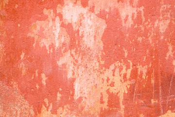 Old peeling pink orange stucco plaster wall texture background