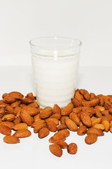 Glass of almond milkn on a white background
