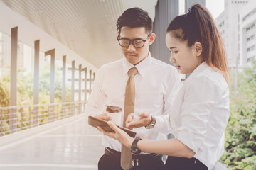 businessman and woman using tablet of working. Meetings the commercial activities in promoting. Together create a mutually beneficial.outside