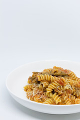 Pasta Sweet Tomato, Aubergine and Ricotta. White background. White plate. Isolated.