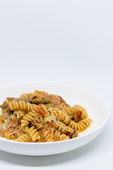 Pasta Sweet Tomato, Aubergine and Ricotta. White background. White plate. Isolated.
