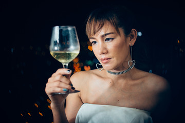 one asian woman vintage style with a flute of wine on white