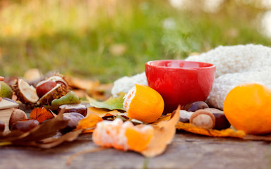 Autumn leaves with hot cup of tea