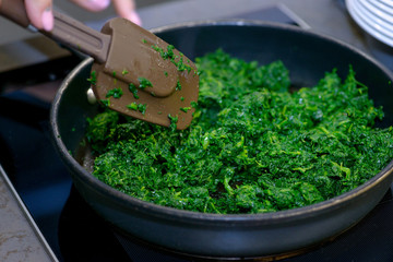 Close-up spinach in pan for sauce