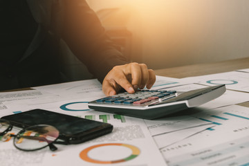 Close up hand of business woman accountant or banker using calculator, business finance calculation concept