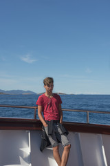 Fototapeta premium Teen boy traveling on the Adriatic Sea with cruise ship