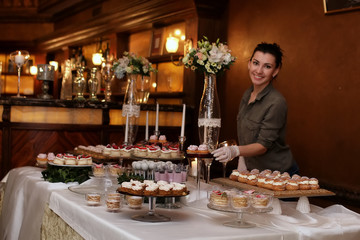 festive table with sweets and a variety of sweet snacks against 