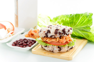 Rice burger with red beans, kimchi, lettuce, tomatoes

