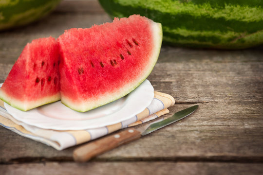 Watermelon on plate with knife