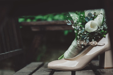 Shiny bridal shoes with bouquet