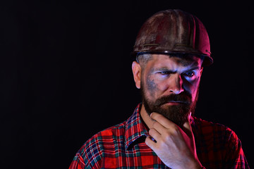 Builder or mine worker with thick beard. Construction and mining