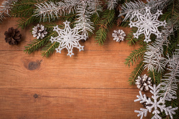 brown wooden background with Christmas decorations, snow cones and twigs spruce