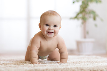 crawling baby boy at home on floor