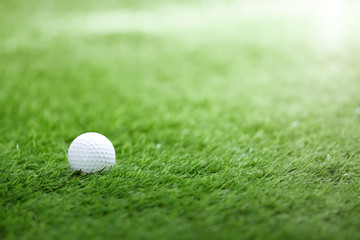 Golf ball on green grass in golf course