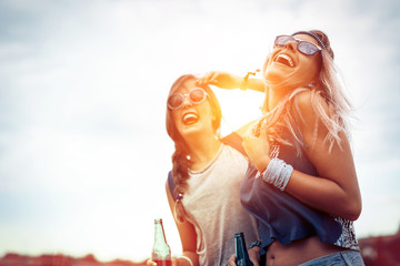 Happy friends laughing and having fun outdoors - obrazy, fototapety, plakaty