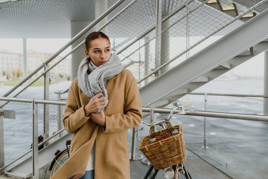 Pretty woman wrapping in coat
