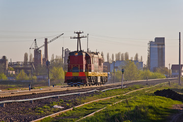 Locomotive train is passing through industrial area