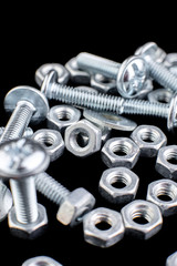 Metal nuts and bolts background. Macro. Working tools. Fixing elements.