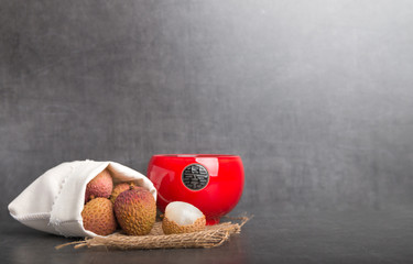 lychees isolated on a grey stone background background