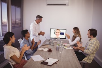 Business people attending video conference in office
