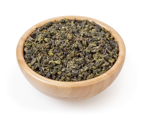 Green oolong tea in wooden bowl isolated on white background with clipping path