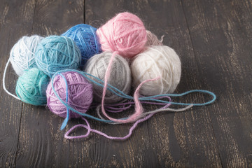 balls of wool on wooden table