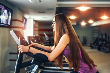 Fototapeta na wymiar Long hair pretty girl training in the gym