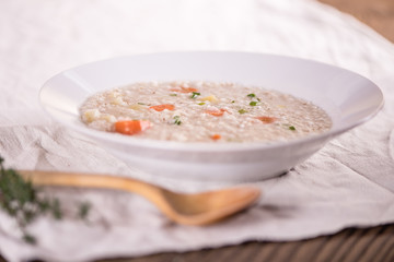 close up of a healthy taste barley soup with root vegetables