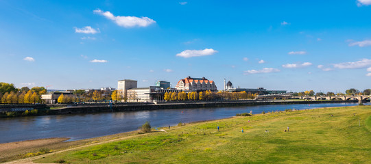 Fototapeta na wymiar Scenic autumn view of Elbe river, Augustus Bridge and Old Town, Dresden, Saxony, Germany, Europe